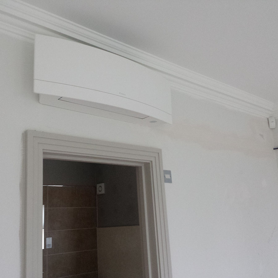 Daikin Emura wall mounted system with pipework run in the wall.